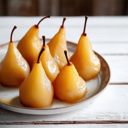 poached cinnamon pears on white wooden table-1